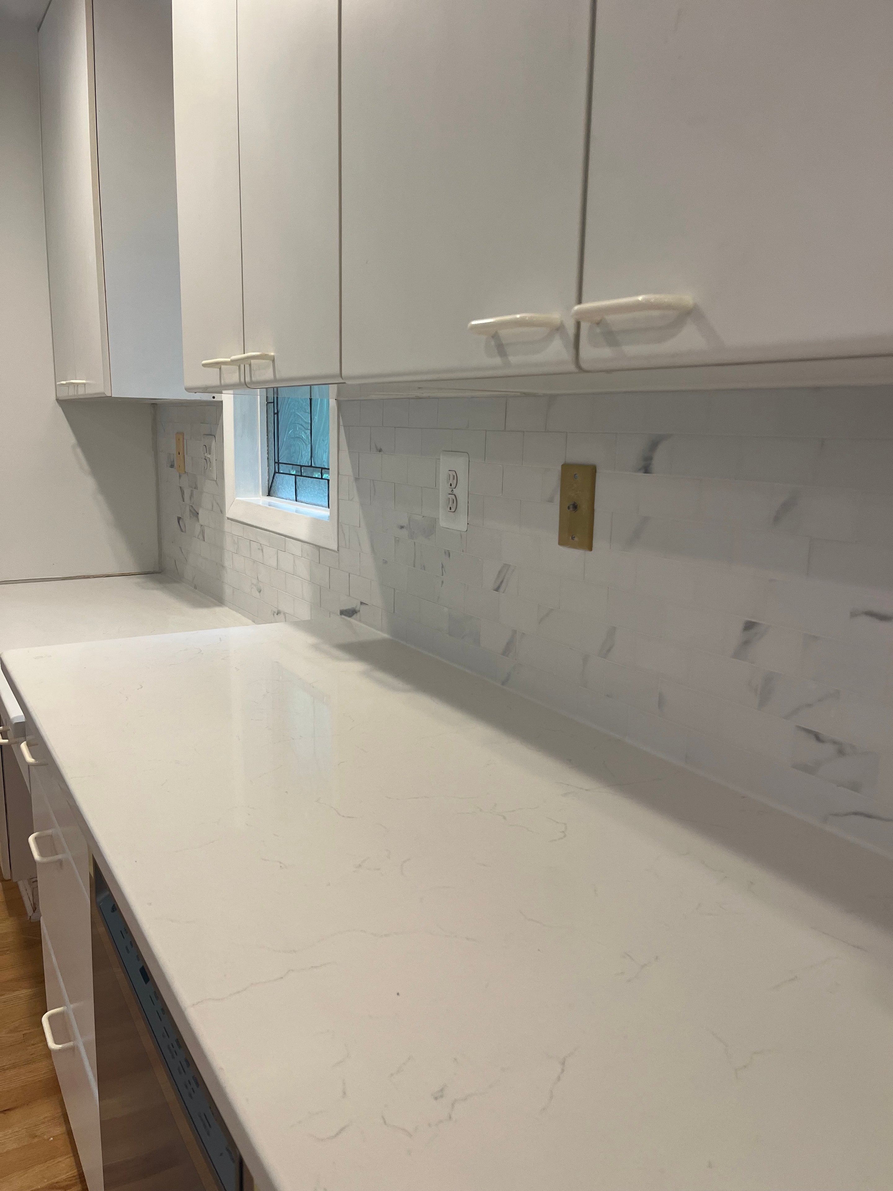 Close-up of quartz countertop and subway tile backsplash installation